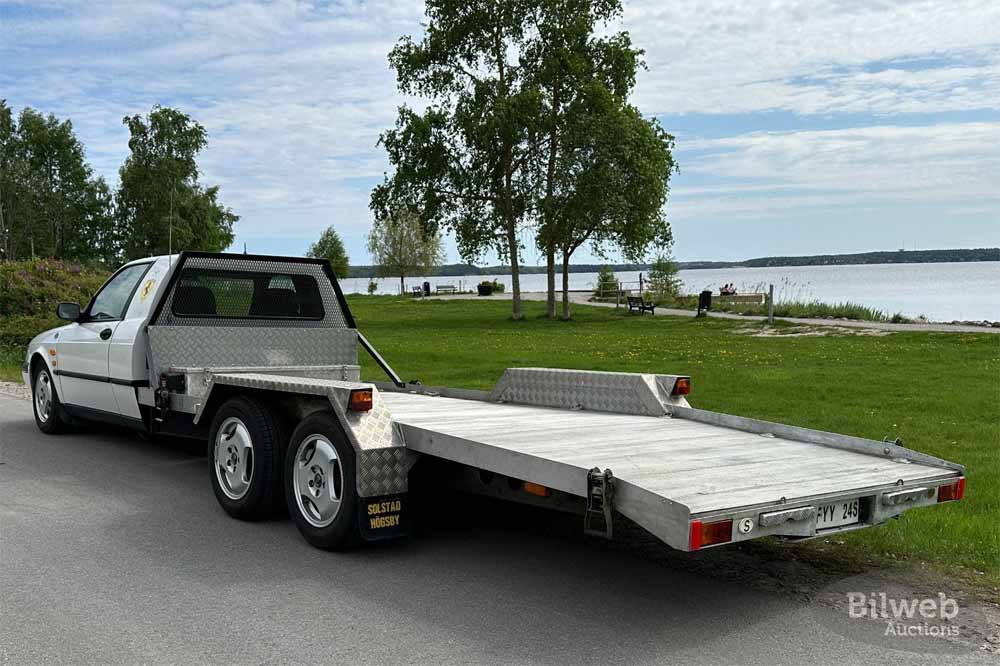 The rear view of the Saab 900 Solstad Transporter highlights its custom flatbed designed for transporting vehicles