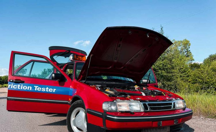 The rare 1996 Saab 9000 SFT, recently rescued and restored by Igor Stankov and his family, showcased in all its glory. This unique friction tester vehicle, originally used at an airport, has only 25,000 kilometers on the odometer and features a distinctive red color, setting it apart from the typical yellow SFT cars.