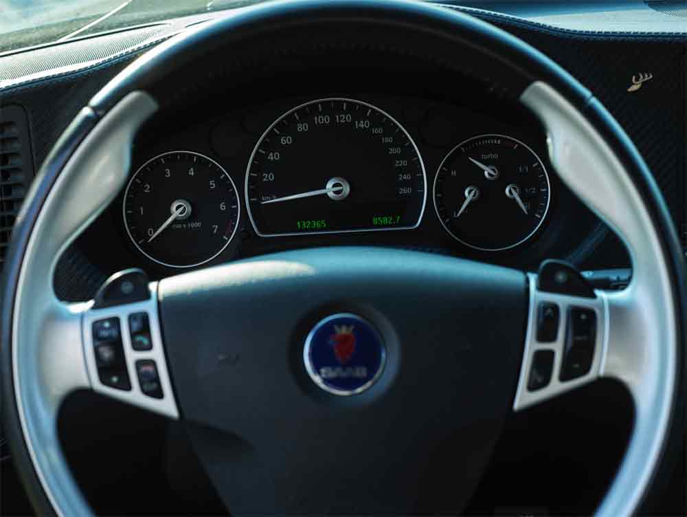 The iconic Saab Aero steering wheel, known for its ergonomic design and sporty aesthetic, featuring intuitive controls and a distinctive emblem that speaks to Saab's aviation heritage. 