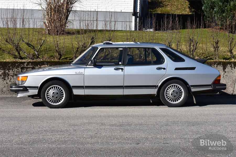 Profile view of the classic 1983 Saab 900 Turbo, capturing its iconic design and aerodynamic lines, complete with the distinctive turbo insignia and inimitable Alu wheels.