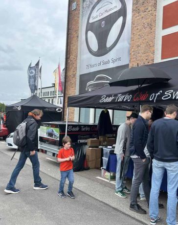 Enthusiasts gather at the Saab Turbo Club of Sweden booth during the 2024 Saab Festival in Trollhättan, celebrating 75 years of Saab Spirit. (photo by Marko Nikitović)