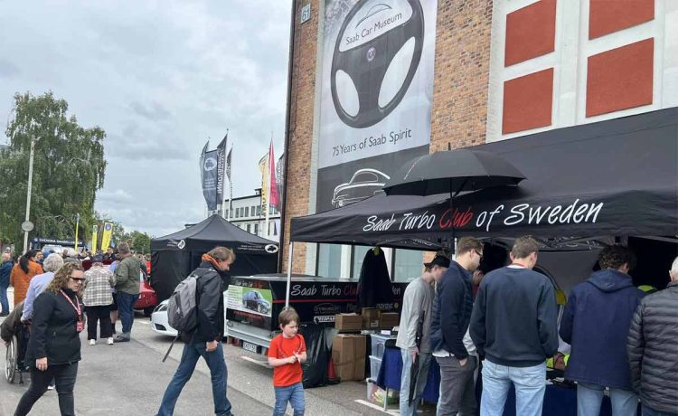 Enthusiasts gather at the Saab Turbo Club of Sweden booth during the 2024 Saab Festival in Trollhättan, celebrating 75 years of Saab Spirit. (photo by Marko Nikitović)