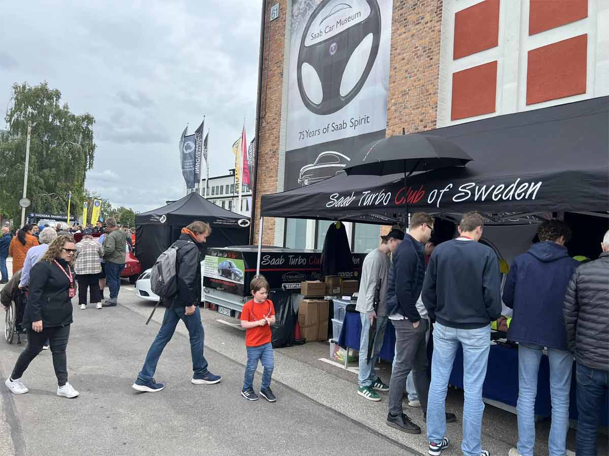 Enthusiasts gather at the Saab Turbo Club of Sweden booth during the 2024 Saab Festival in Trollhättan, celebrating 75 years of Saab Spirit. (photo by Marko Nikitović)