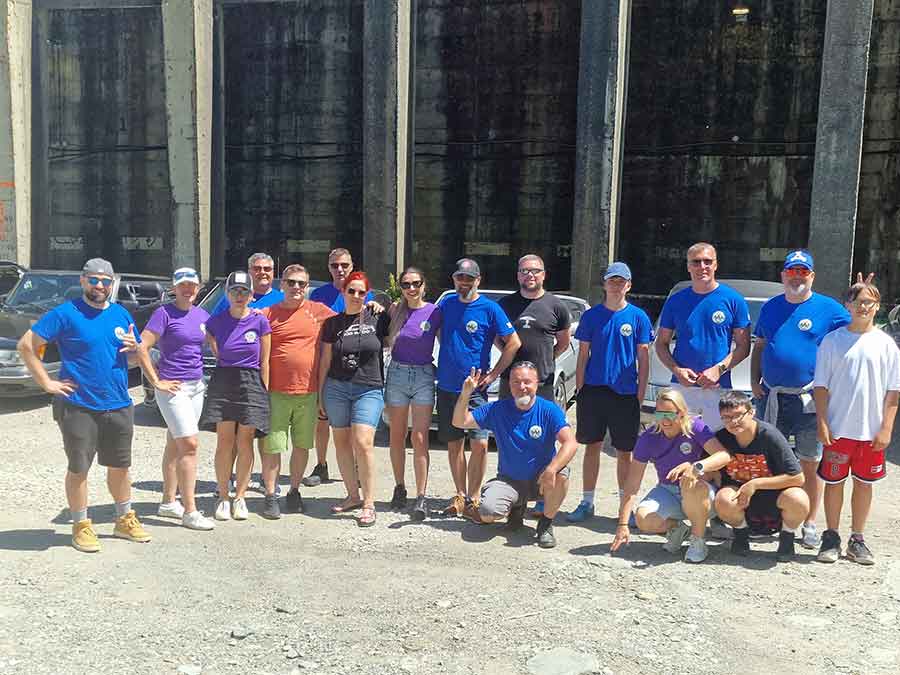 Members of the Saab Club Romania pose for a group photo during their Transylvania tour, celebrating their shared passion for Saab cars and the strong sense of community within the club.