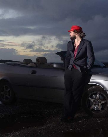 Louis Raban-Ledger with his Saab Convertible – the inspiration behind his visually striking tribute book to Saab’s legacy.