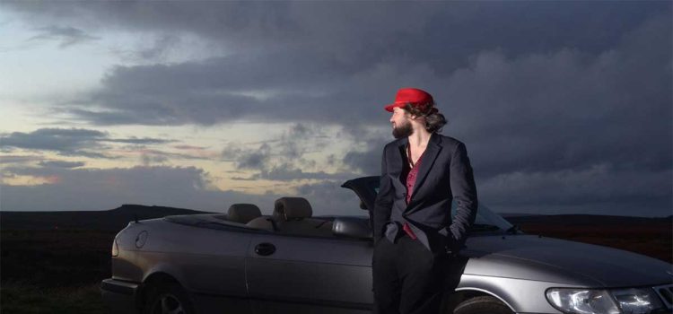 Louis Raban-Ledger with his Saab Convertible – the inspiration behind his visually striking tribute book to Saab’s legacy.