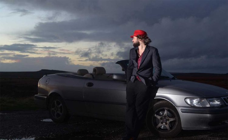 Louis Raban-Ledger with his Saab Convertible – the inspiration behind his visually striking tribute book to Saab’s legacy.