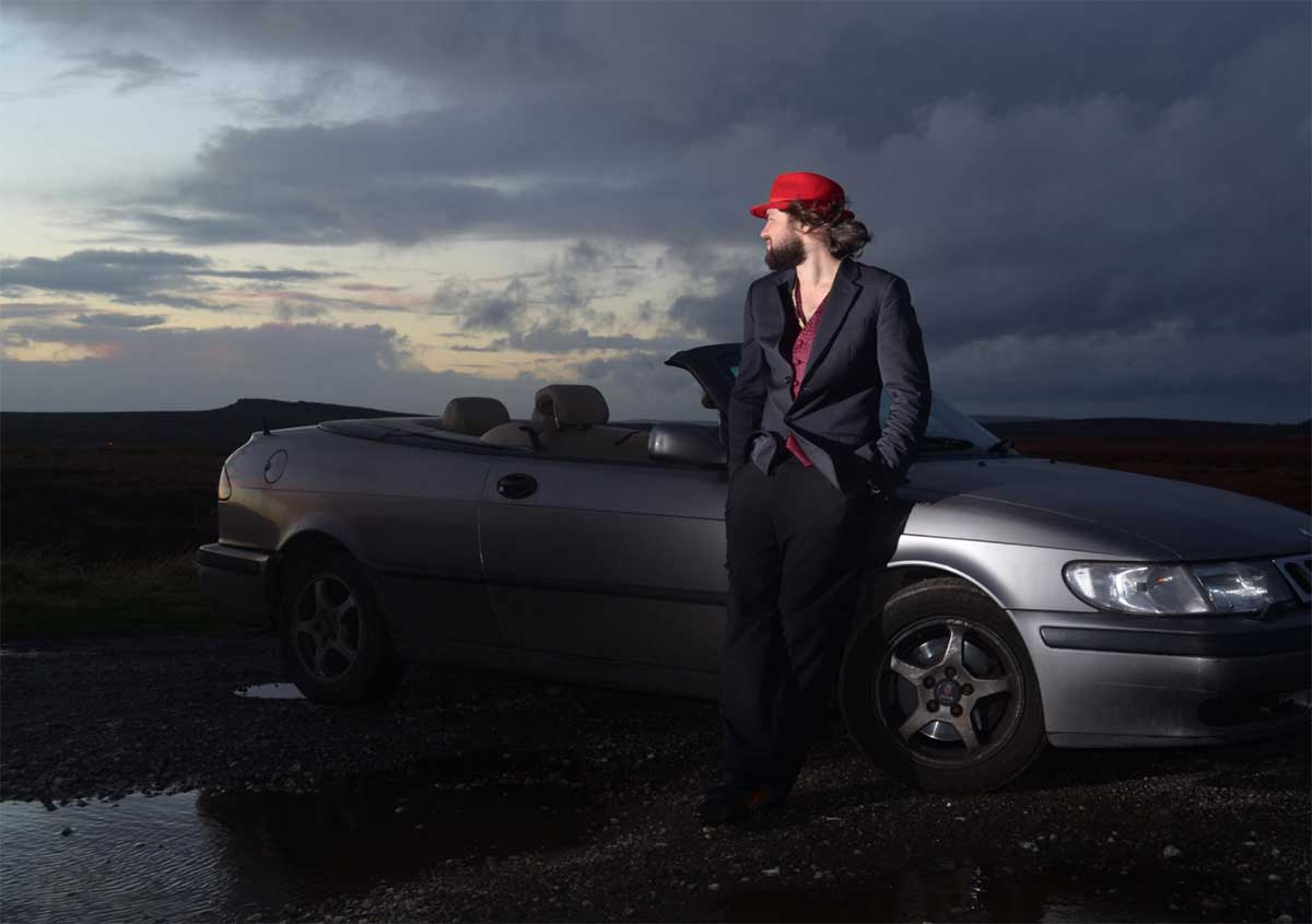 Louis Raban-Ledger with his Saab Convertible – the inspiration behind his visually striking tribute book to Saab’s legacy.