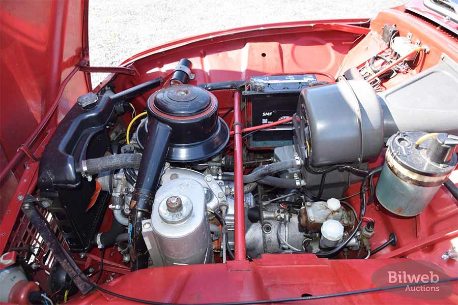 The engine bay of this 1966 Saab 96 Monte Carlo 850 is impeccably clean, featuring its iconic three-cylinder two-stroke engine, expertly rebuilt to maintain peak performance.