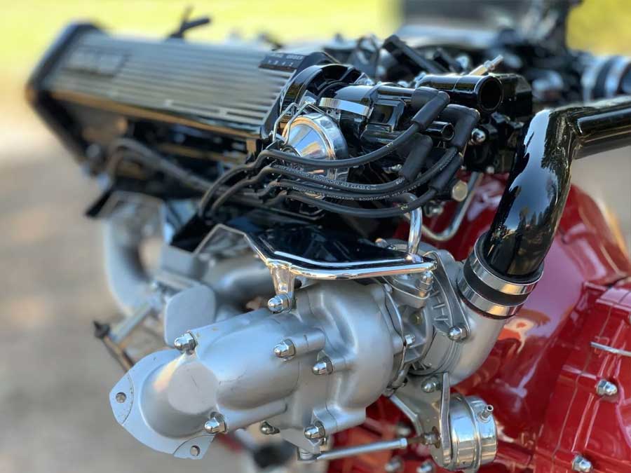 A close-up of the Saab 900 Turbo show engine’s intricate fuel injection and ignition components — a testament to Saab’s engineering prowess in the early 1980s.