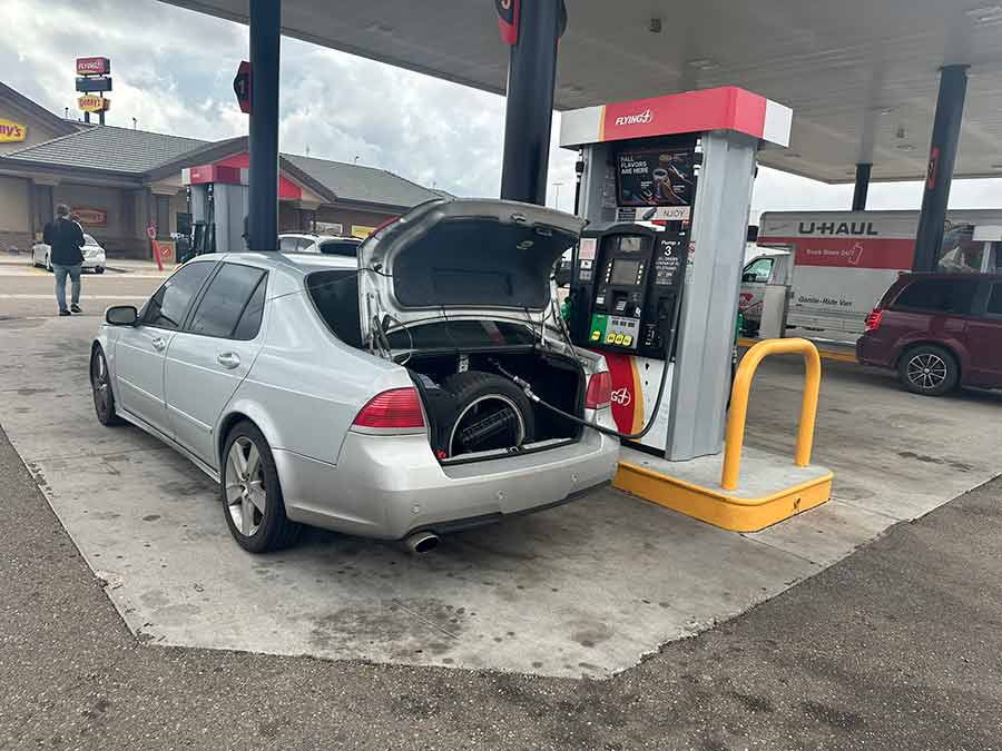 One of the brief refueling stops: the Saab 9-5 Aero prepped and ready to continue its record-breaking Cannonball Run journey.