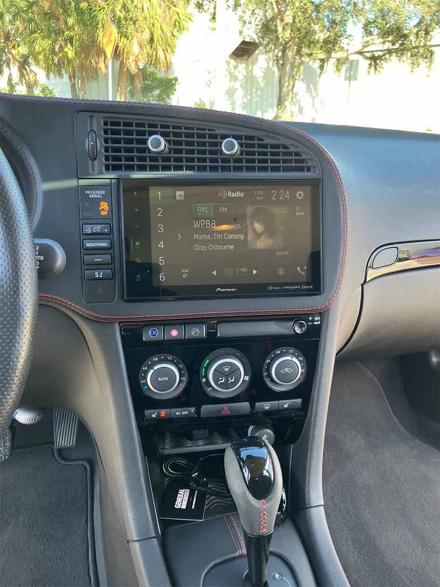 The custom interior of this 2008 Saab 9-3 Aero SportCombi features a Pioneer touchscreen stereo with Apple CarPlay, premium Bose audio system, and red-stitched black leather trim—a modernized take on Saab’s driver-focused cockpit.