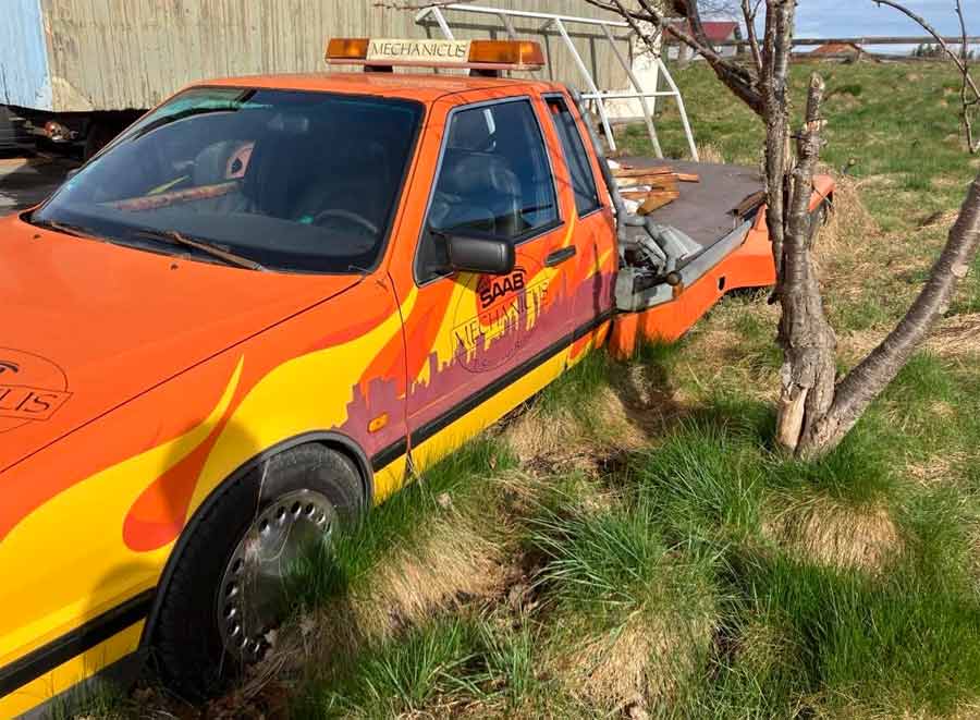 Once a proud transporter of Saab legacy, this Saab 9000 now stands abandoned, enveloped by the unforgiving embrace of nature, a somber reflection of past glory.