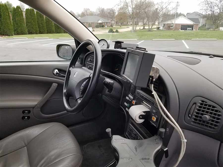 The control panel and integrated touchscreen of the 2004 Saab 9-5 Arc Friction Tester, designed for precision runway surface analysis, combined with Saab’s signature ergonomic dashboard layout.