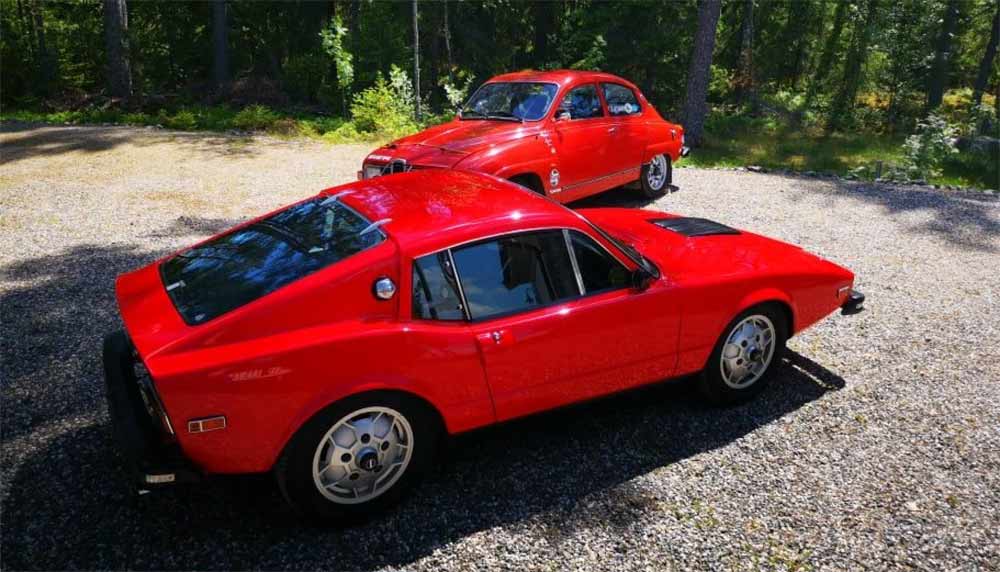 Rolf Asbjørn Haugmo Takes the Wheel of a Rally-Ready 96 V4 (in the background) with Leather Straps over the Hood and Several Stylish Details - Alongside His Danish-Imported Sonett (in the foreground).