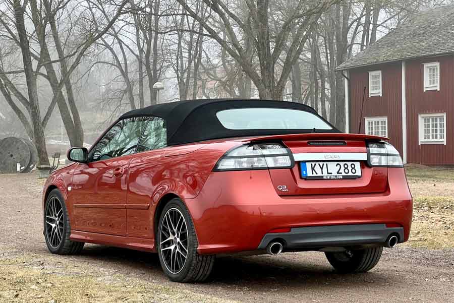 Rear view of the rare Saab 9-3 Aero Cabriolet Independence Edition, showcasing its sleek design and unique Sunset Red color.