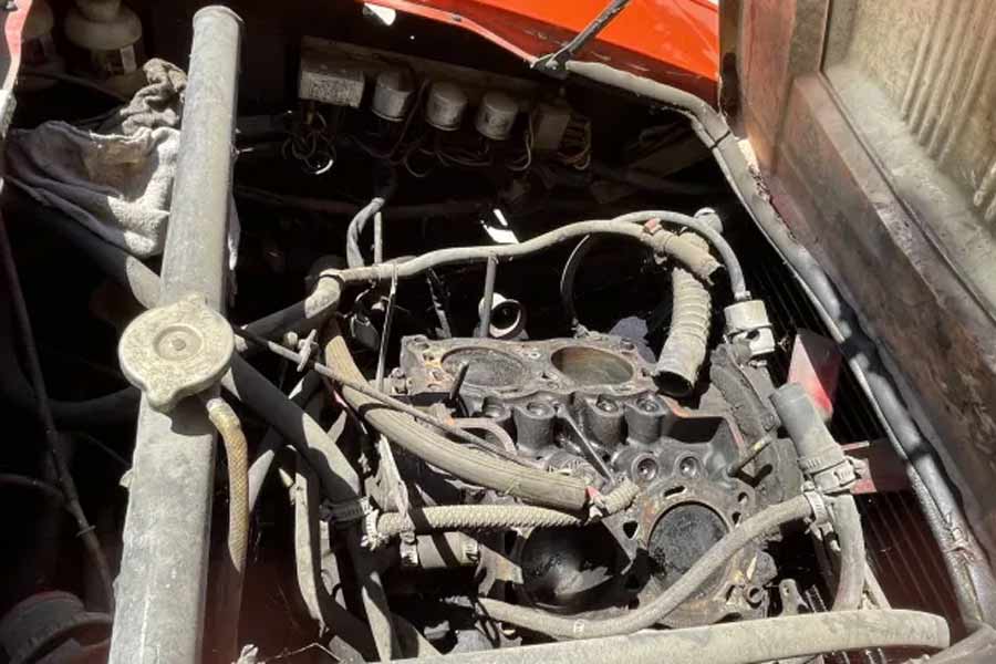 Under the hood of the 1973 Saab Sonett III lies the dormant 1.7-liter Ford Taunus V4, untouched since 1997 with the cylinder heads removed, awaiting revival.