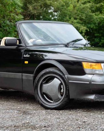 A stunning 1990 Saab 900 T16S FPT Convertible, featuring a sleek black exterior and luxurious cream leather interior, currently up for auction.