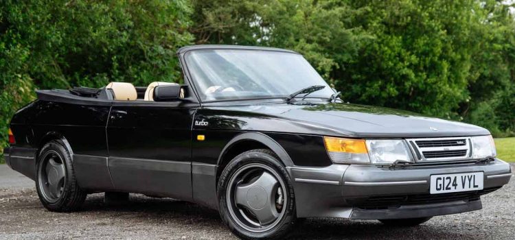 A stunning 1990 Saab 900 T16S FPT Convertible, featuring a sleek black exterior and luxurious cream leather interior, currently up for auction.