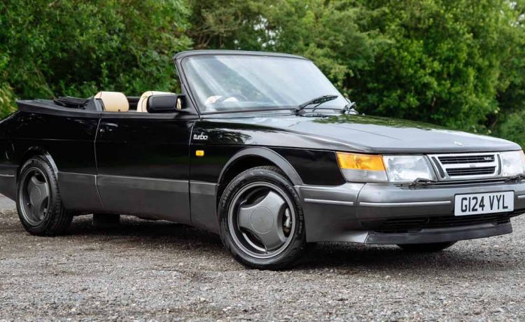 A stunning 1990 Saab 900 T16S FPT Convertible, featuring a sleek black exterior and luxurious cream leather interior, currently up for auction.