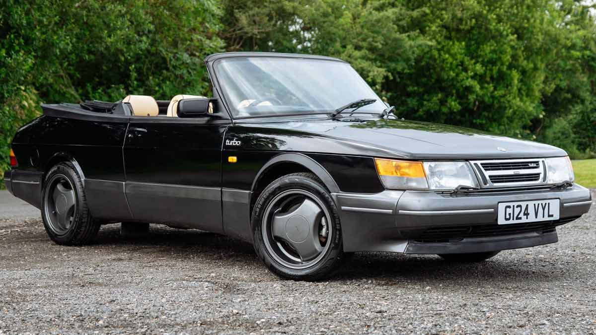 A stunning 1990 Saab 900 T16S FPT Convertible, featuring a sleek black exterior and luxurious cream leather interior, currently up for auction.