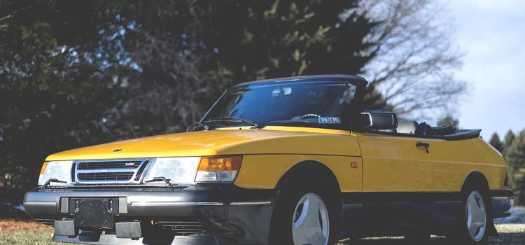 A remarkably preserved 1991 Saab 900 Turbo Convertible in Monte Carlo Yellow, commanding a record auction price of $59,000.