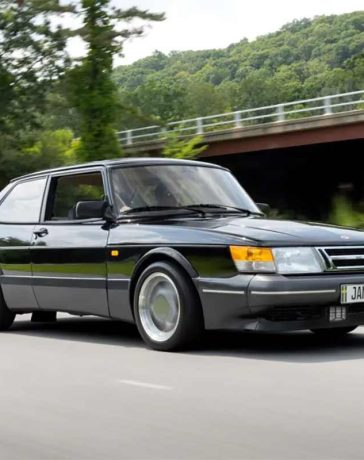 This stunning image of the 1988 Saab 900 Turbo SPG captures the essence of this rare and iconic vehicle, showcasing its sleek black exterior, aerodynamic design, and classic three-spoke Aero wheels, making it a perfect representation of the car's legendary performance and style.