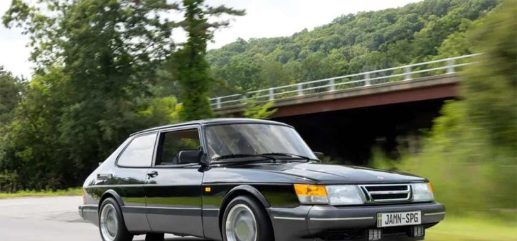 This stunning image of the 1988 Saab 900 Turbo SPG captures the essence of this rare and iconic vehicle, showcasing its sleek black exterior, aerodynamic design, and classic three-spoke Aero wheels, making it a perfect representation of the car's legendary performance and style.