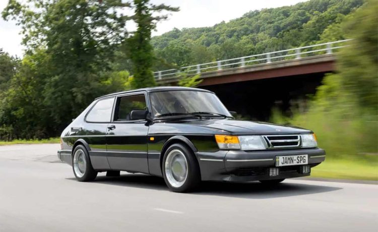 This stunning image of the 1988 Saab 900 Turbo SPG captures the essence of this rare and iconic vehicle, showcasing its sleek black exterior, aerodynamic design, and classic three-spoke Aero wheels, making it a perfect representation of the car's legendary performance and style.