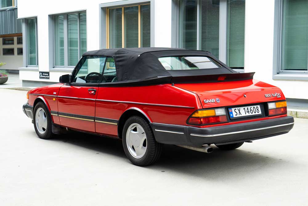 Saab 900 Turbo Convertible: Iconic red elegance on wheels, epitomizing the legacy of Swedish automotive craftsmanship.