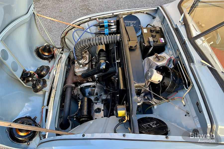 Under the hood of the 1955 Saab 92B De Luxe lies its heart—a meticulously restored 764cc two-stroke engine, delivering 28 horsepower with Saab's innovative freewheeling feature, a testament to mid-century engineering.