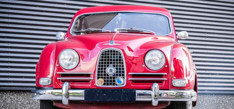 Polished and poised, this red 1957 Saab 93B classic showcases its elegant Swedish design and timeless appeal.