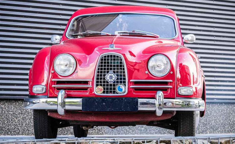 Polished and poised, this red 1957 Saab 93B classic showcases its elegant Swedish design and timeless appeal.