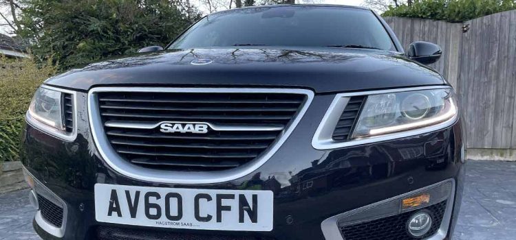 Front View of the 2010 Saab 9-5 Aero: Showcasing its sleek black elegance and the distinctive design that marks Saab's engineering prowess.