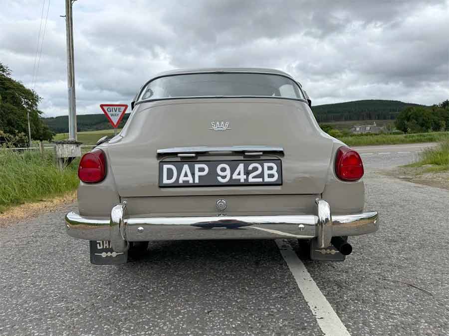 The rear view of the 1964 Saab 96, showcasing its timeless design and flawless restoration—a true icon of Swedish automotive craftsmanship, ready for its next journey.