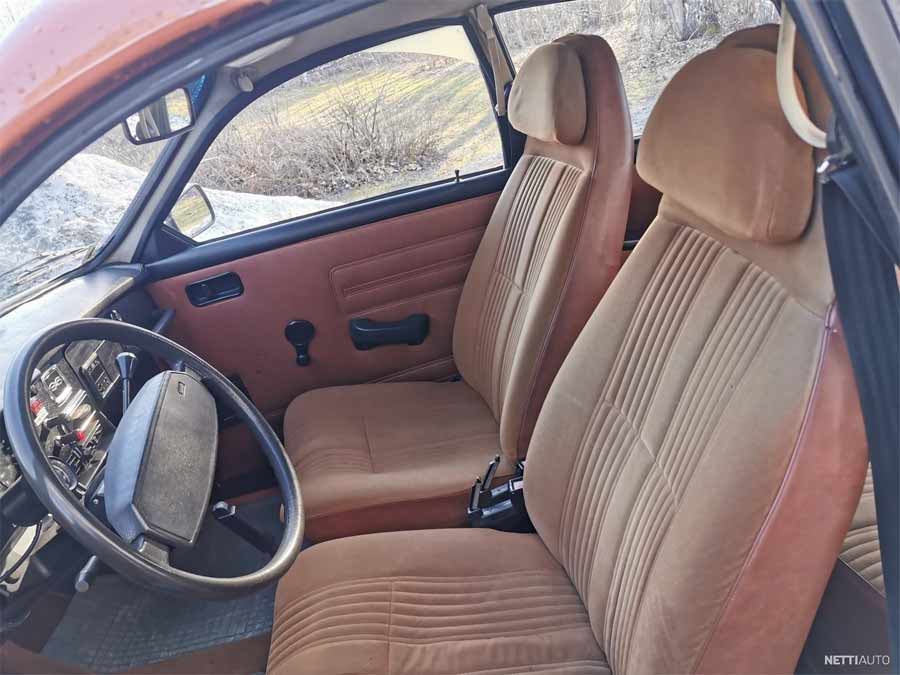 Interior view of the 1979 Saab 96 GL V4 Super, featuring well-preserved tan upholstery and original dashboard, exuding classic charm and simplicity.