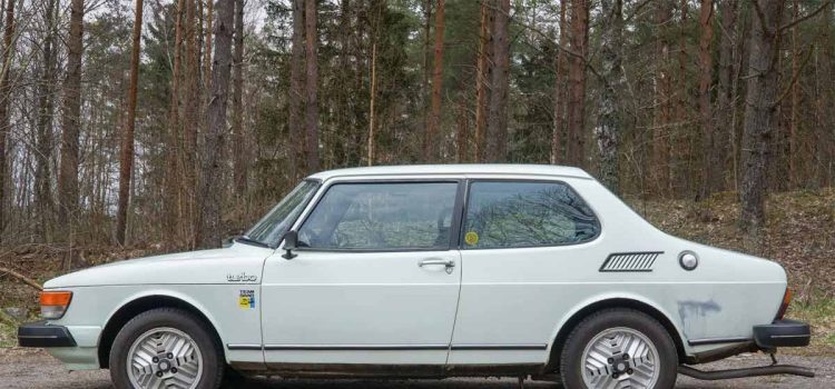 1980 Saab 99 Turbo showcased in a serene forest setting, highlighting its classic design and distinctive turbo features.