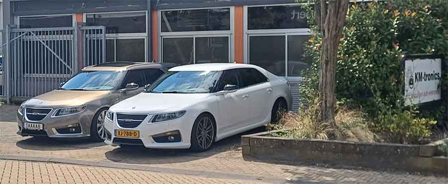 Two pristine Saab 9-5NG models, including a rare Hirsch Performance edition, parked outside KM-tronics. These cars exemplify the dedication of Saab enthusiasts who rely on KM-tronics for top-tier OEM-quality parts and restorations to keep their Saabs in excellent condition.