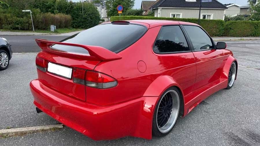 the Saab 900 2.0T WideSide Edition, showcasing its custom spoiler, widened rear fenders, and aggressive body kit, embodying a unique blend of Saab heritage and modern design innovation.