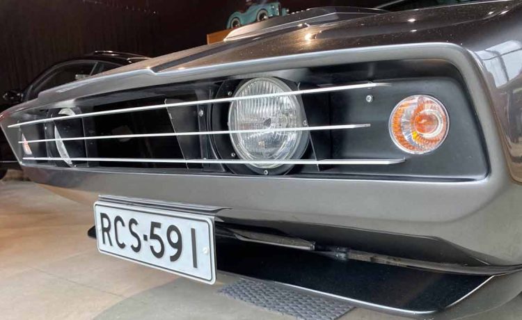 Close-up of the front grille and headlights of a 1973 Saab Sonett III, showcasing its distinctive design and well-maintained condition, featuring a Finnish registration plate.