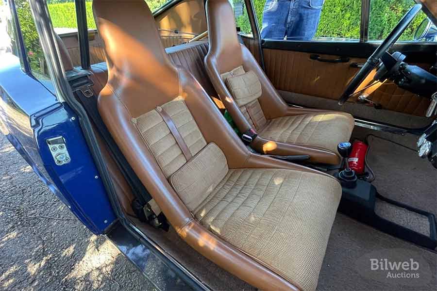 Caption: The interior of the 1972 Saab Sonett III, featuring handcrafted seats and panels by Top n Trim, was completely renovated during the 14-year restoration process, resulting in a pristine and well-maintained cabin.