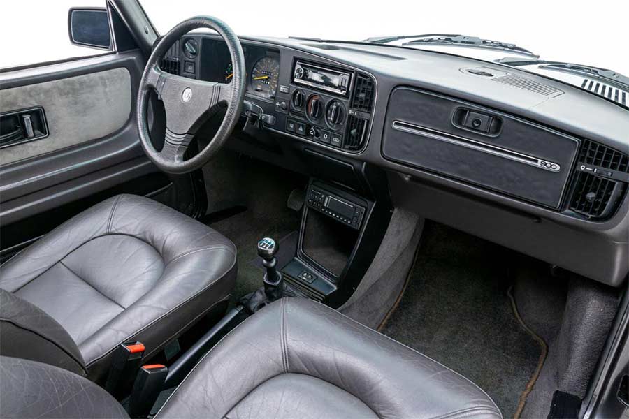 The interior of the 1986 Saab 900 SPG, featuring Scottish Bridge of Weir leather-trimmed seats and a meticulously maintained dashboard, blending luxury with classic Saab design.