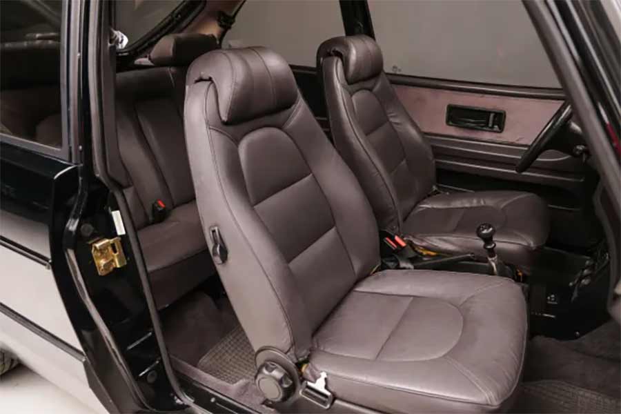 The interior of this 1988 Saab 900 Turbo SPG is immaculately preserved, featuring Buffalo Gray leather upholstery, heated front bucket seats, and a Saab/Clarion AM/FM/cassette stereo system, exemplifying the comfort and luxury that complement its high-performance engineering.