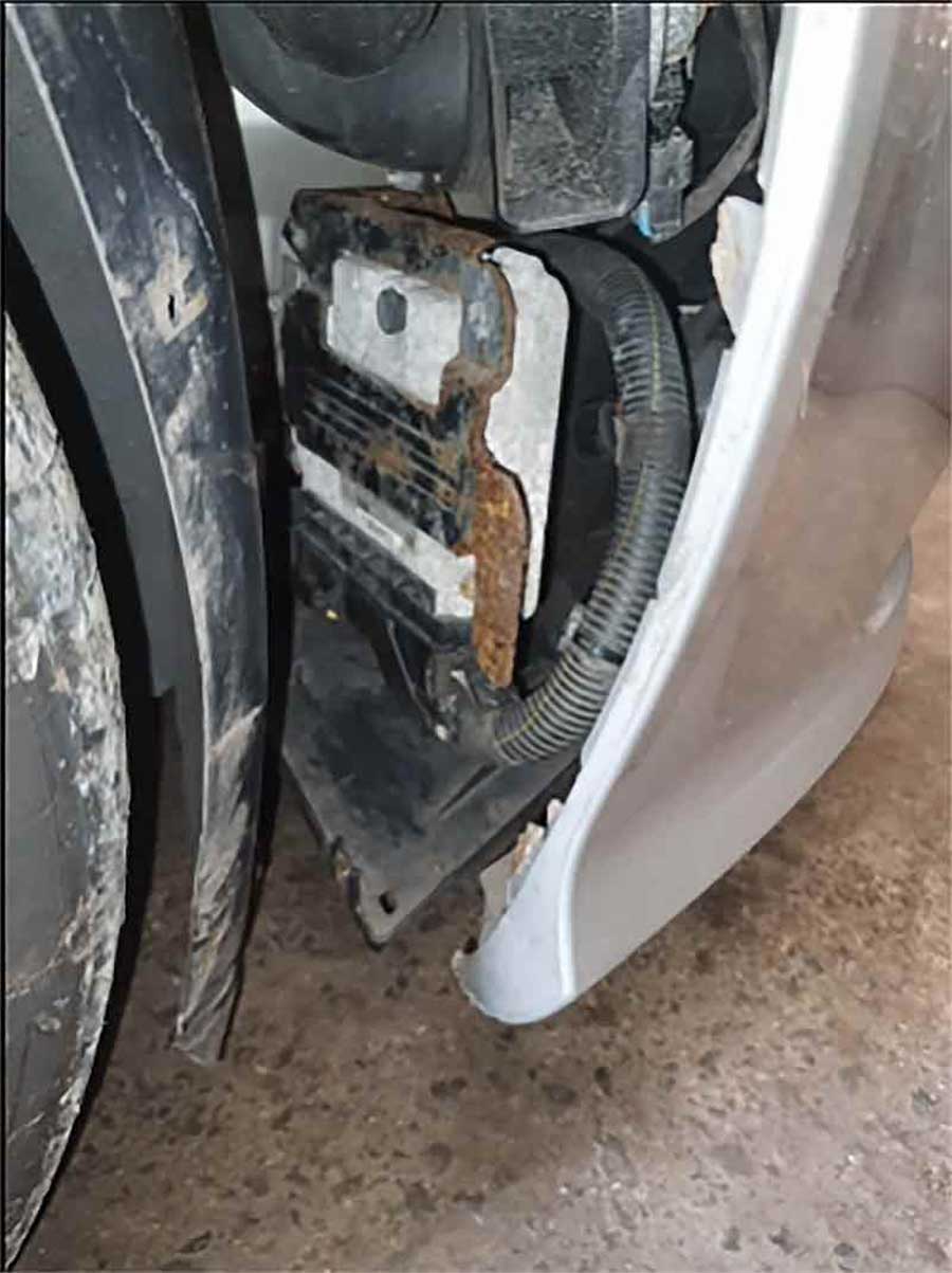 The original location of the Saab 9-3 TTiD ECU, positioned in the front right wheel well, exposing it to moisture, salt, and road debris. This example shows severe rust and corrosion on the ECU mount, highlighting the urgent need for relocation to prevent costly failures.