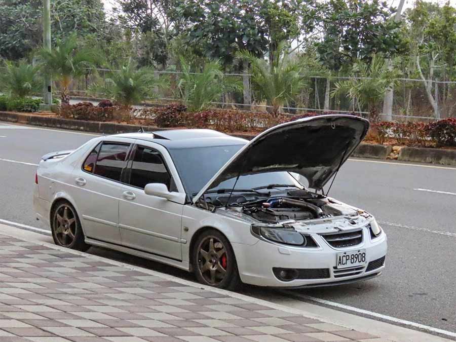 Under the hood of the meticulously upgraded 2006 Saab 9-5 Aero, revealing the powerful engine setup capable of nearly 500 horsepower, paired with Hirsch Performance wheels and AP Racing brakes.