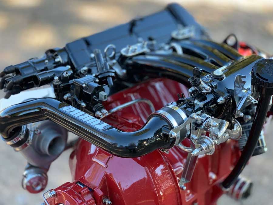 Detailed view of the Saab 900 Turbo engine’s polished intake and turbocharger connections, reflecting the advanced design principles that made Saab a pioneer in turbocharged performance.