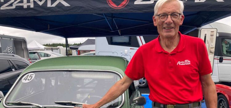 Joyful driver and writer, celebrating a second-place trophy after a race on the historic circuit at Anderstorp Raceway