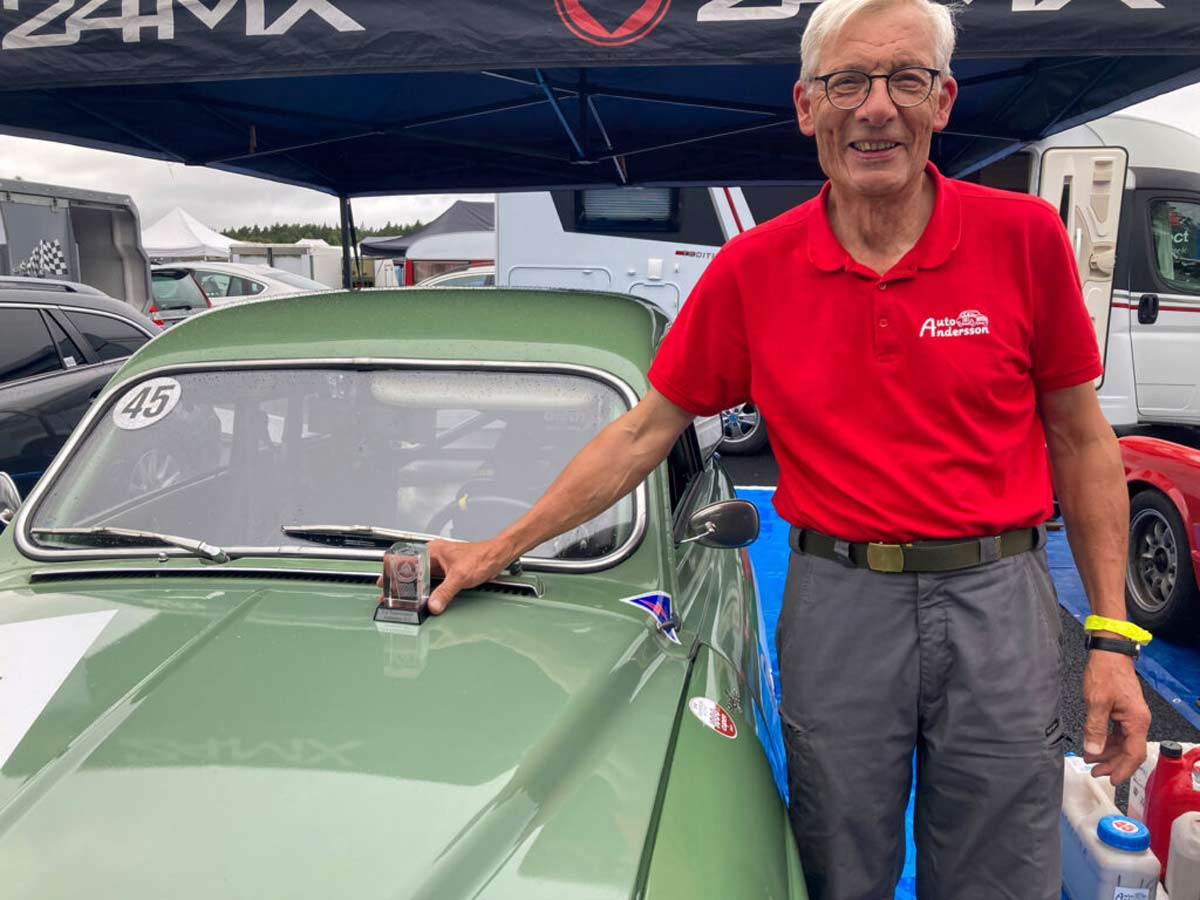 Joyful driver and writer, celebrating a second-place trophy after a race on the historic circuit at Anderstorp Raceway