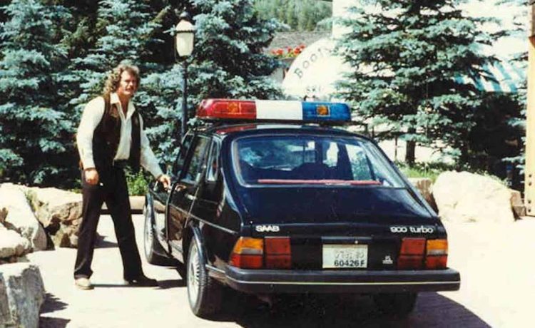 During the late 1970s or early 1980s, Vail Police Officer Pat McCullough examines one of the department's newly acquired Saab patrol cars, as the department marks its 50th anniversary this week.