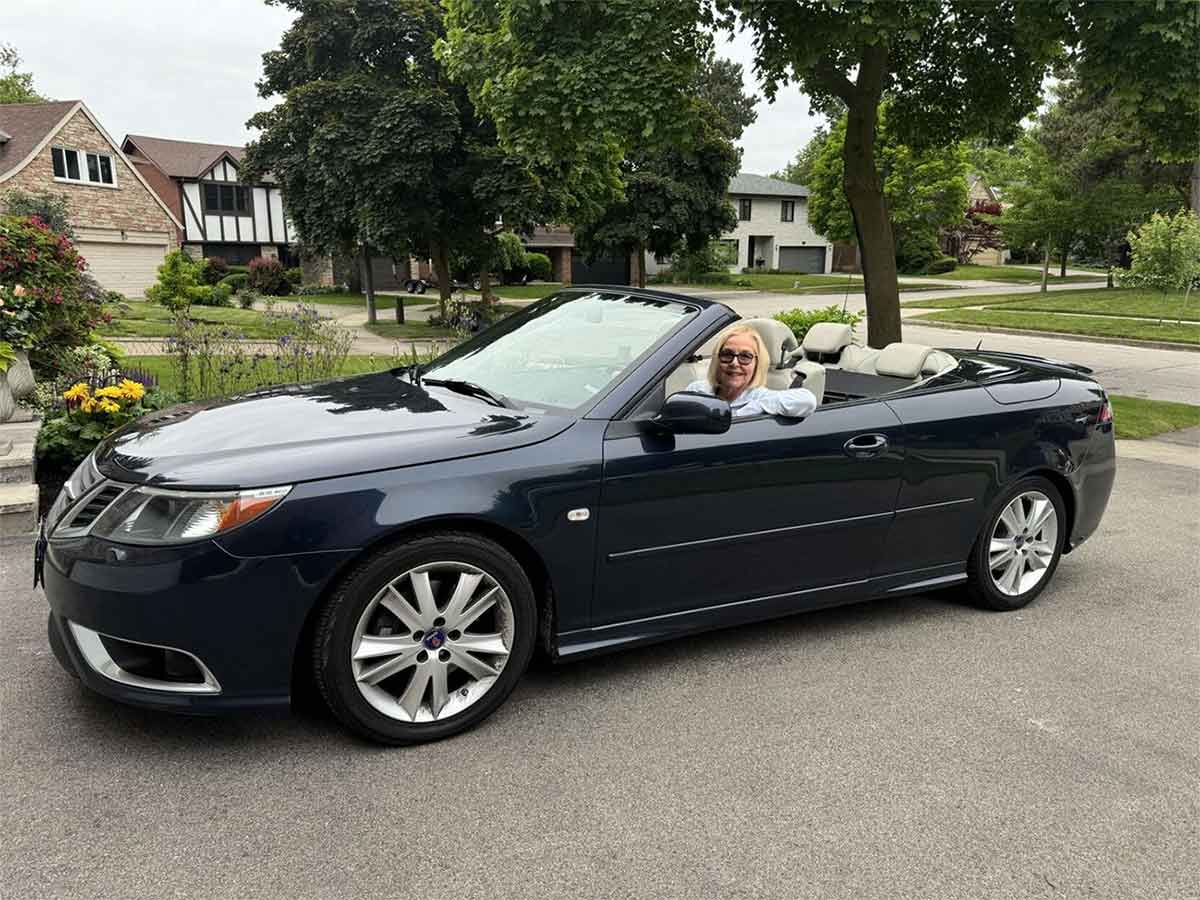 Vicki Griffiths enjoys the freedom of driving through the Caledon Hills in her navy blue 2008 Saab 9-3 Convertible with the top down.